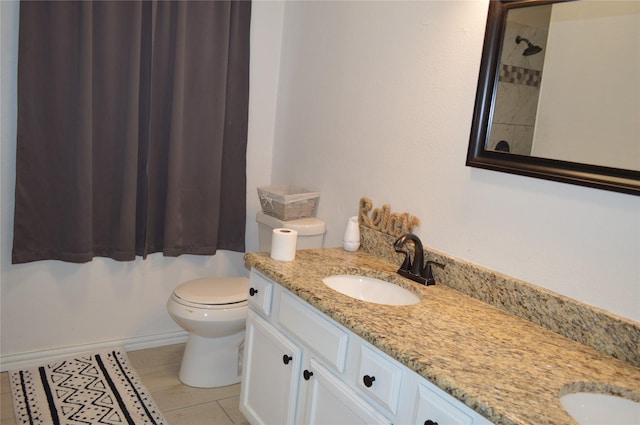 bathroom featuring vanity, tile patterned flooring, a shower, and toilet