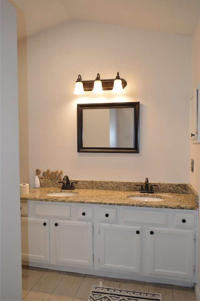 bathroom with vanity and vaulted ceiling