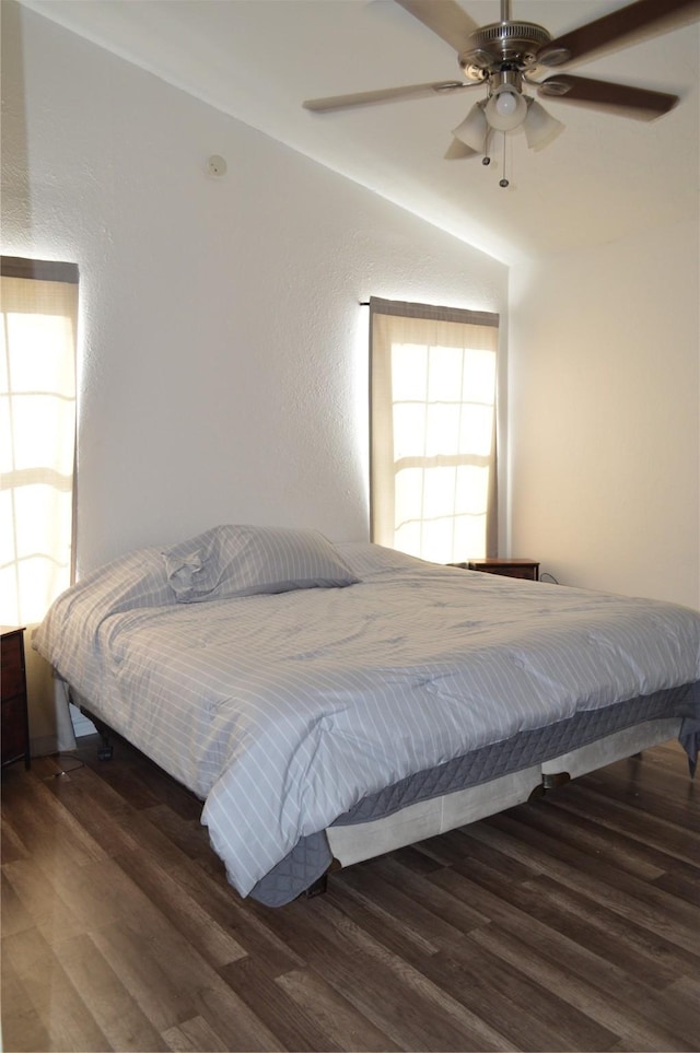 bedroom with dark hardwood / wood-style floors and ceiling fan