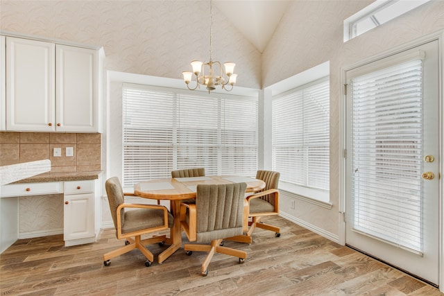 dining space with vaulted ceiling, plenty of natural light, and light wood-type flooring