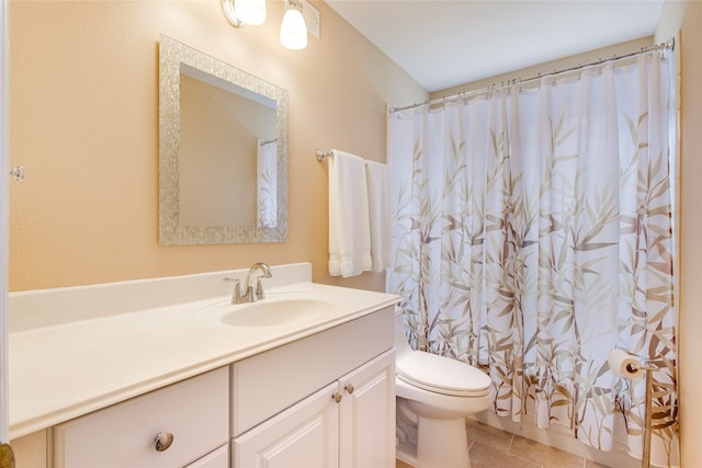 bathroom featuring vanity, toilet, and tile patterned flooring