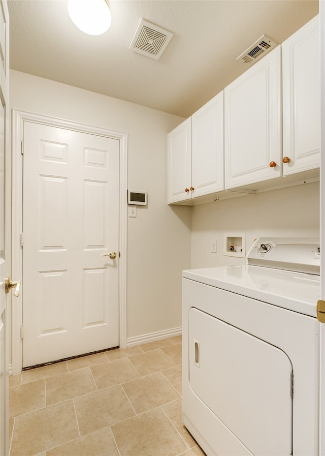 laundry area featuring washer / clothes dryer, light tile patterned floors, and cabinets