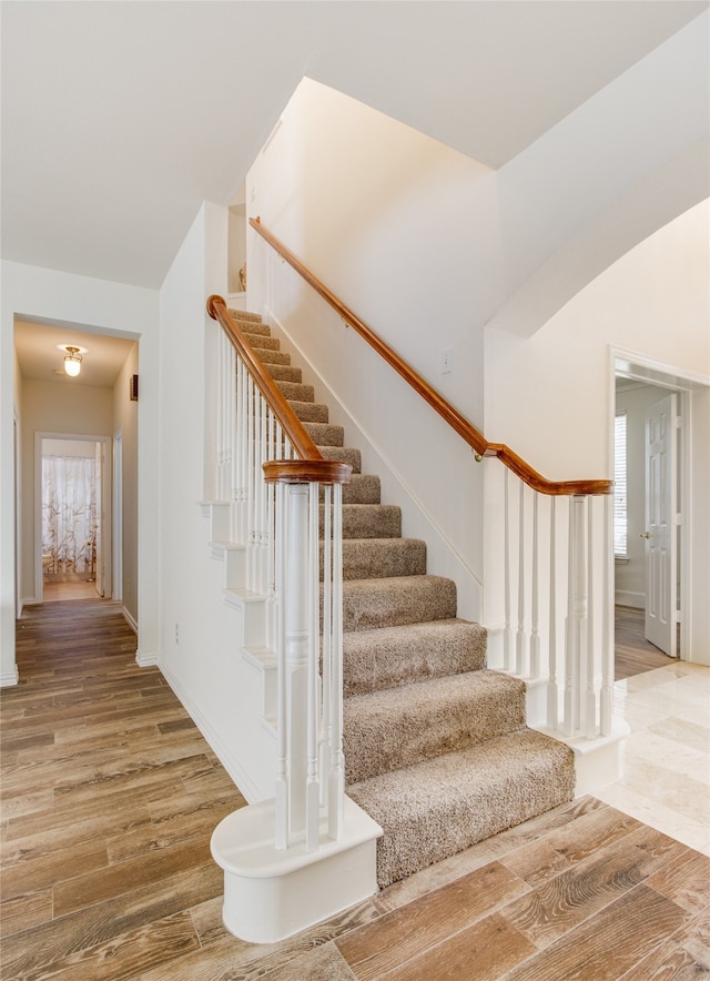 stairs featuring wood-type flooring