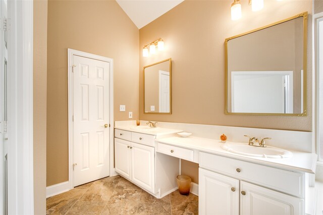 bathroom featuring vanity and vaulted ceiling