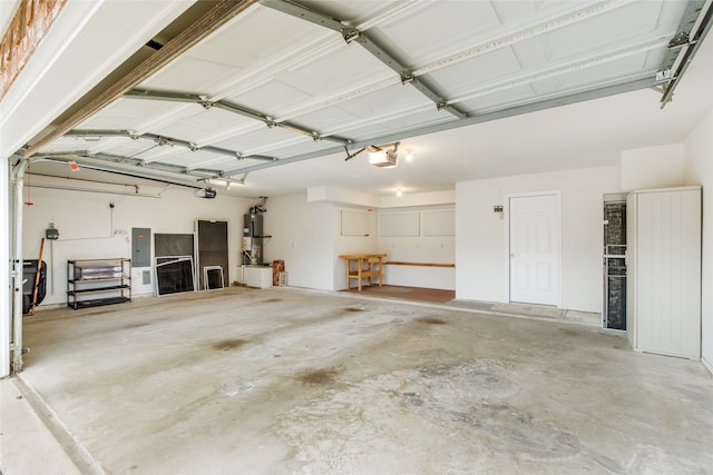 garage with a garage door opener, electric panel, and water heater