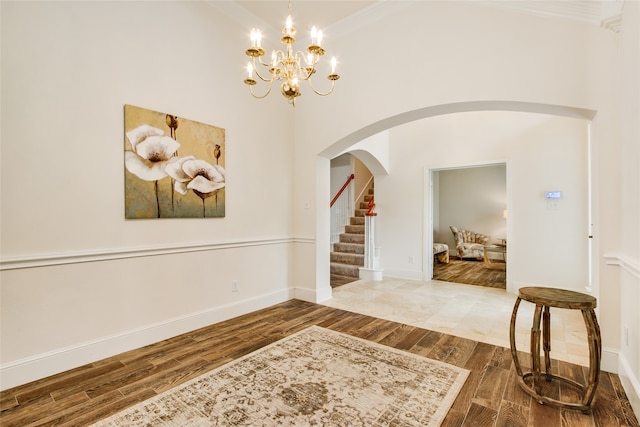 entrance foyer with crown molding and hardwood / wood-style floors