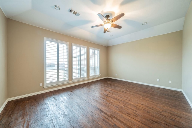 empty room featuring ceiling fan, lofted ceiling, and dark hardwood / wood-style floors