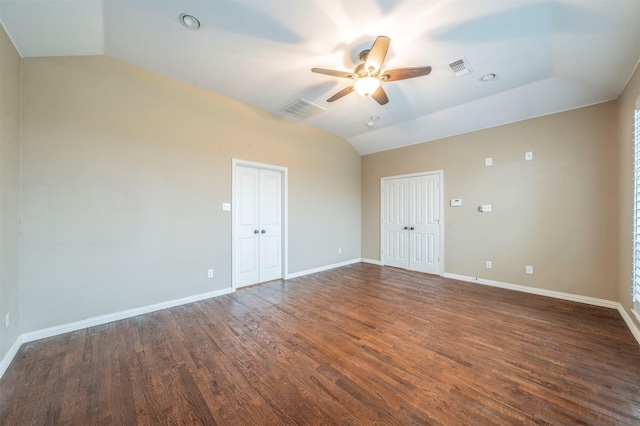 unfurnished room featuring ceiling fan, dark hardwood / wood-style flooring, and vaulted ceiling