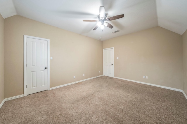 carpeted empty room featuring ceiling fan and lofted ceiling