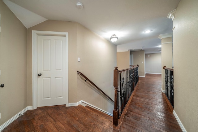 staircase featuring lofted ceiling and wood-type flooring