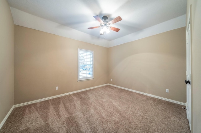 carpeted spare room with ceiling fan and vaulted ceiling