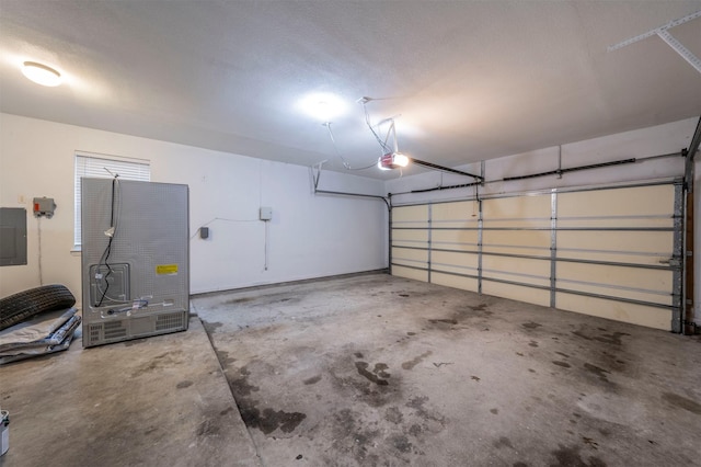 garage with a garage door opener and electric panel