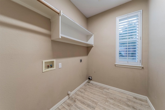 washroom featuring hookup for a washing machine, hookup for an electric dryer, and light hardwood / wood-style floors