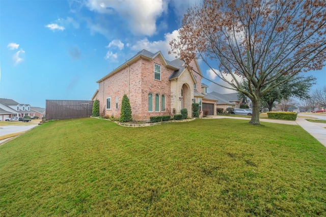 view of front of property featuring a garage and a front lawn