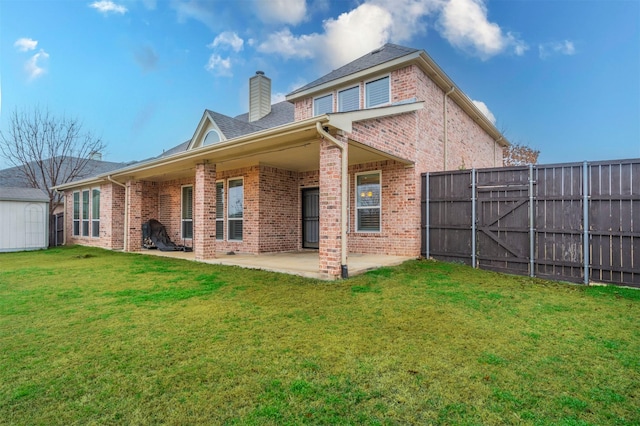 rear view of house featuring a yard and a patio area