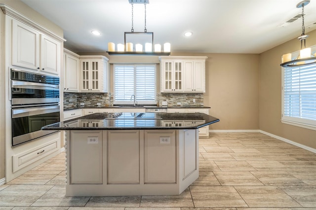 kitchen featuring a notable chandelier, hanging light fixtures, and a kitchen island