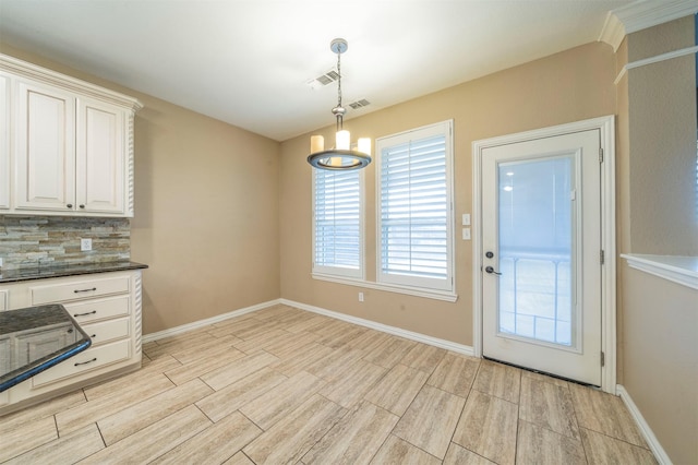 kitchen with pendant lighting, backsplash, and a chandelier