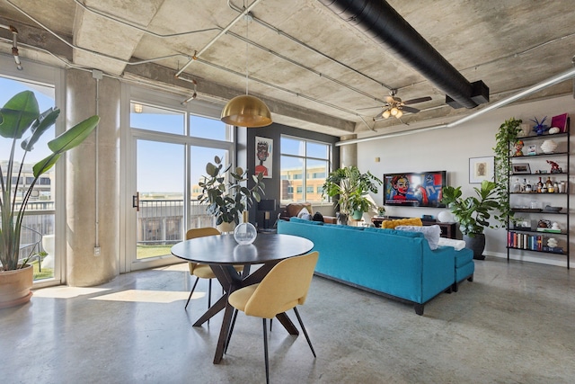 interior space with a ceiling fan and concrete flooring