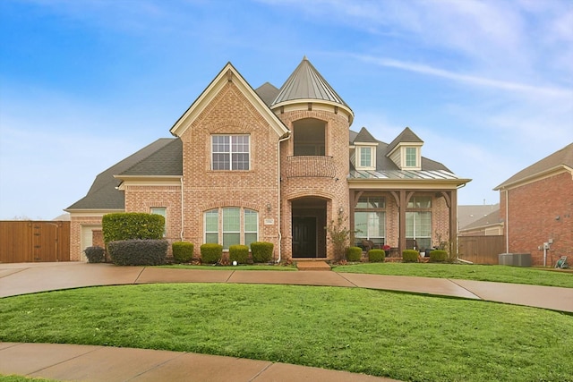 view of front of home featuring central AC and a front lawn