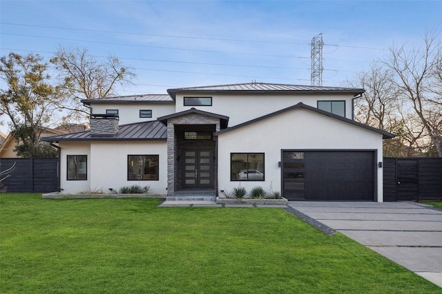 view of front of house featuring a garage and a front yard