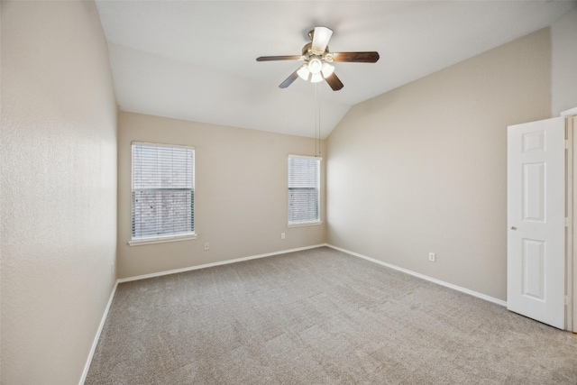 spare room with lofted ceiling, light colored carpet, and ceiling fan