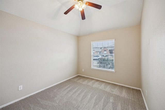 carpeted spare room with vaulted ceiling and ceiling fan