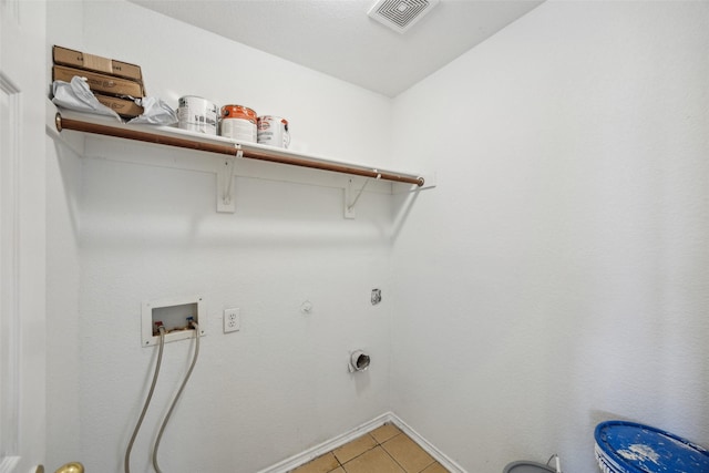 laundry area with gas dryer hookup, electric dryer hookup, washer hookup, and light tile patterned floors