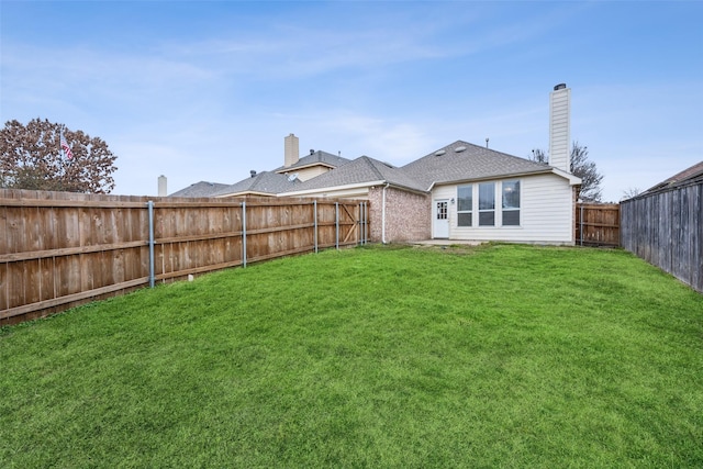 rear view of property with a yard