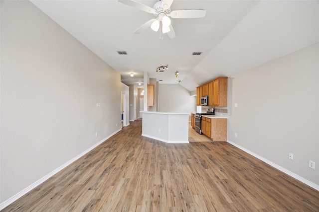 unfurnished living room with ceiling fan, lofted ceiling, and light hardwood / wood-style floors