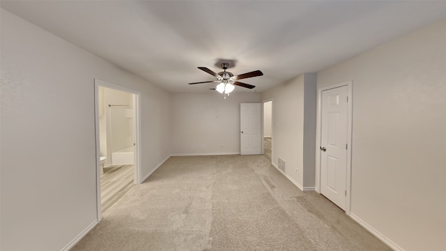 carpeted spare room with ceiling fan