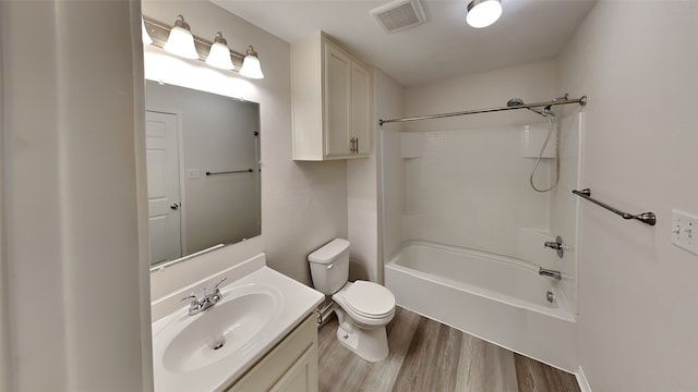 full bathroom featuring vanity, hardwood / wood-style flooring, shower / bathtub combination, and toilet