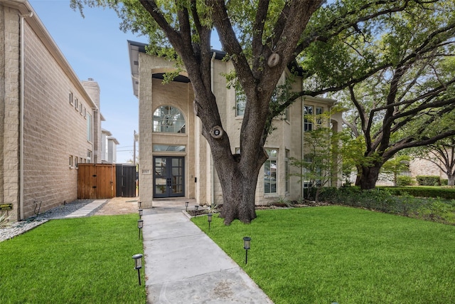 view of front facade with a front yard and french doors