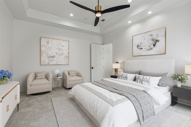 bedroom featuring light carpet, crown molding, a raised ceiling, and ceiling fan