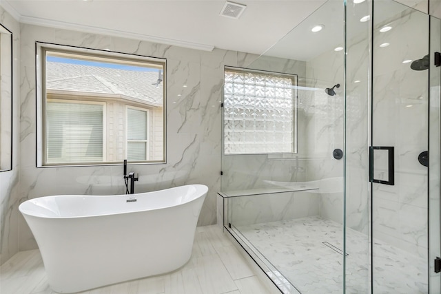 bathroom featuring ornamental molding and shower with separate bathtub