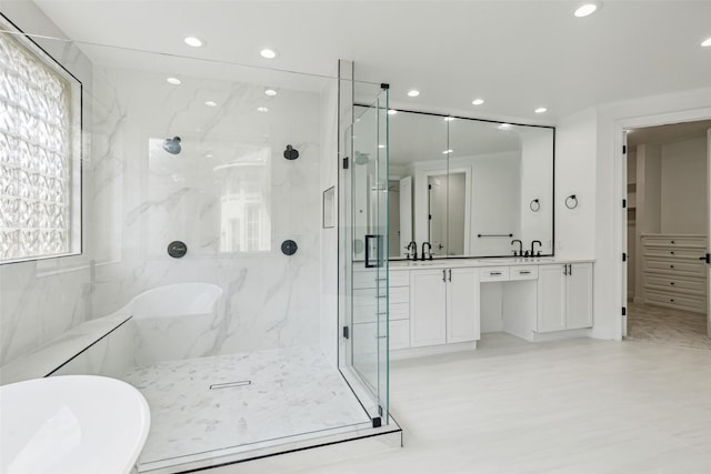 bathroom featuring vanity and separate shower and tub