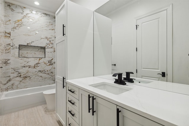 full bathroom featuring tiled shower / bath combo, vanity, and toilet