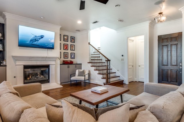 living room featuring ornamental molding, hardwood / wood-style floors, and ceiling fan