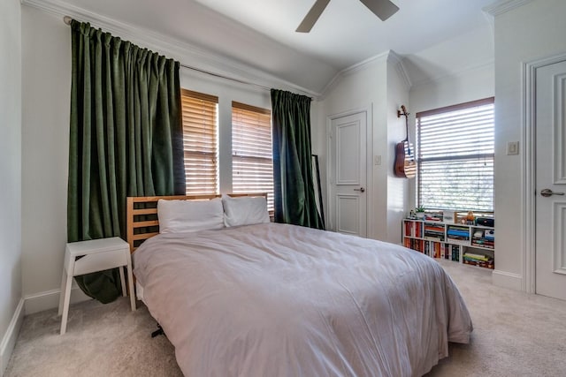 bedroom featuring ornamental molding, vaulted ceiling, light carpet, and ceiling fan