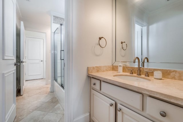 bathroom featuring vanity, crown molding, and bath / shower combo with glass door