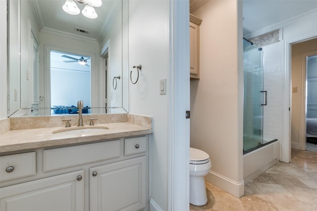 full bathroom featuring toilet, crown molding, bath / shower combo with glass door, vanity, and ceiling fan