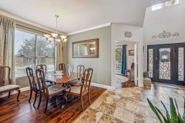 dining area with crown molding, wood-type flooring, and a notable chandelier