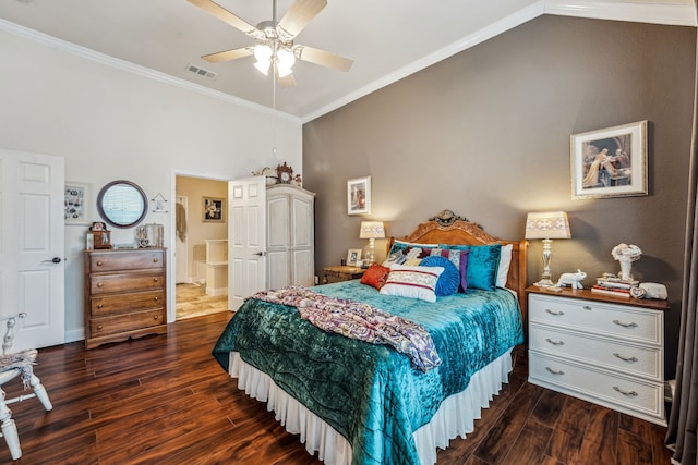 bedroom featuring dark wood-type flooring, ornamental molding, and vaulted ceiling