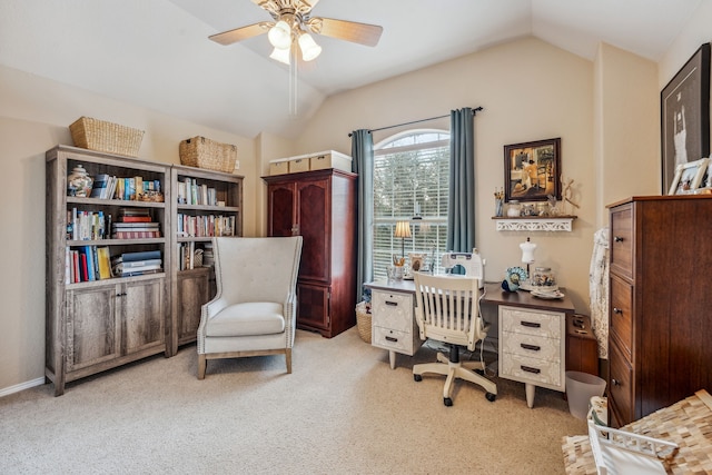 carpeted home office featuring vaulted ceiling and ceiling fan