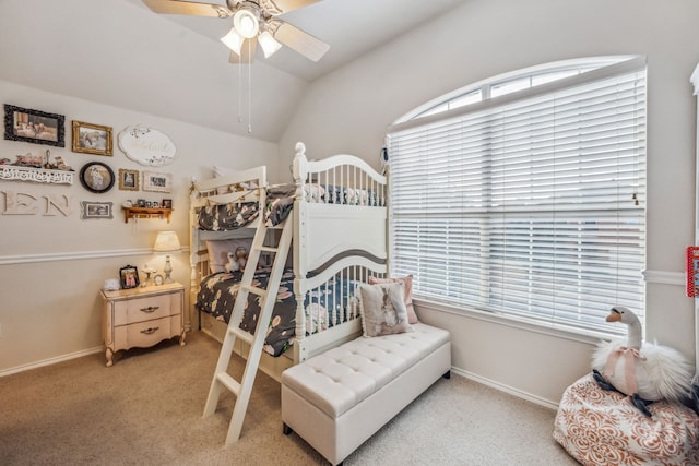 bedroom featuring multiple windows, vaulted ceiling, light colored carpet, and ceiling fan