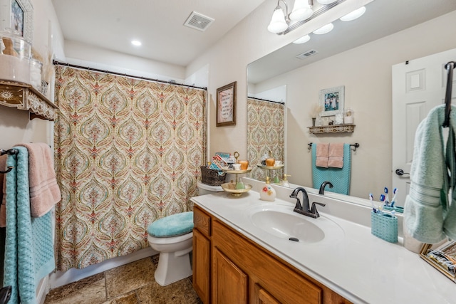 bathroom featuring vanity and toilet