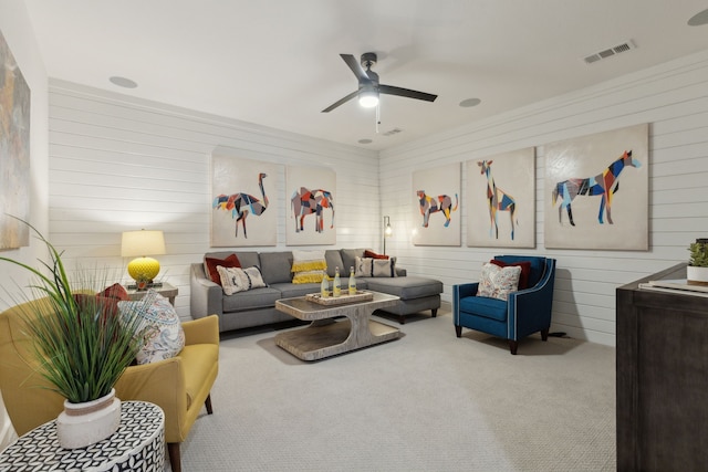 carpeted living room with ceiling fan