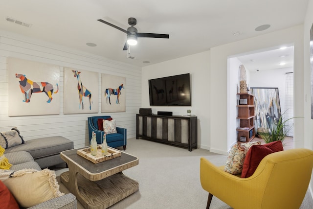 living room with light colored carpet and ceiling fan