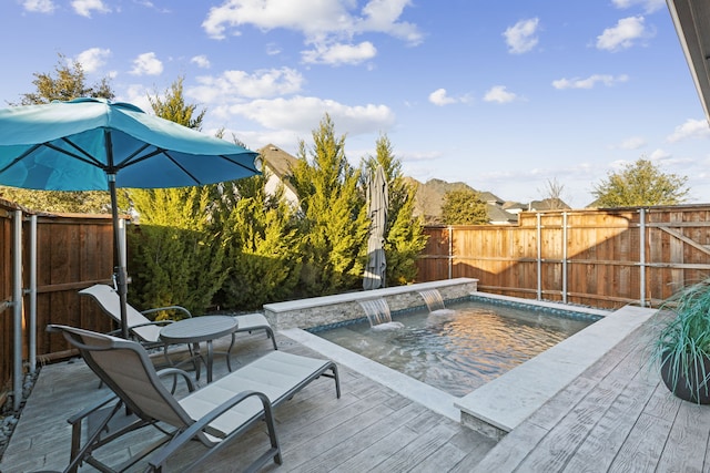 view of swimming pool with pool water feature and a deck