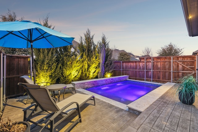 view of swimming pool with a wooden deck and an in ground hot tub