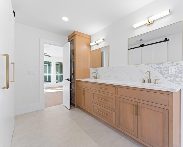 bathroom featuring vanity, a tub, tile patterned floors, and decorative backsplash